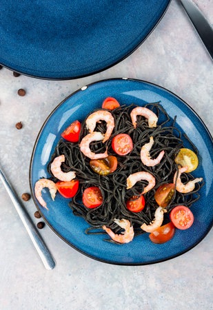 Vegetarian black spaghetti or pasta with prawn and tomatoes. Healthy food concept.の写真素材