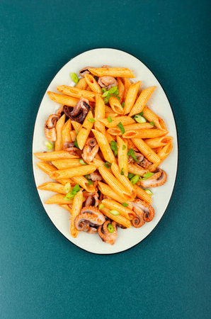 Macaroni or pasta boiled with octopus in white dish. Macaroni with seafood. Italian foodの写真素材