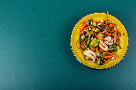 Salad of cucumber, onion and octopus. Korean food. Korean cuisine with seafood. Copy space.の写真素材