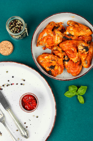 Baked chicken wings with chili sauce in a plate. Top view, flat layの写真素材