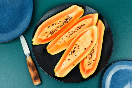Sliced fresh juicy papaya on the table. Beautiful papaya fruits.の写真素材