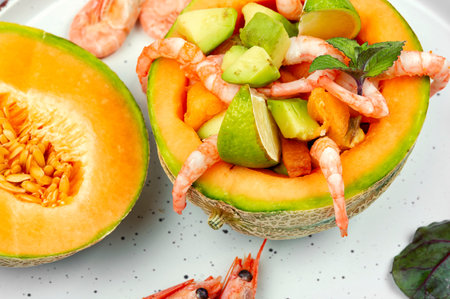 Salad, fruit salad of prawn, shrimp, melon and avocado in melon.の写真素材