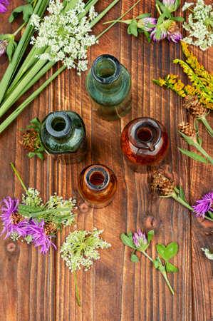 Medicinal, healing mixtures and decoctions from medicinal herbs on wooden background.の写真素材