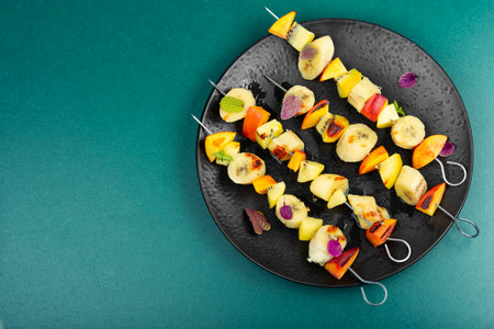 Delicious and homemade skewers with many exotic fruits. Copy space.の写真素材