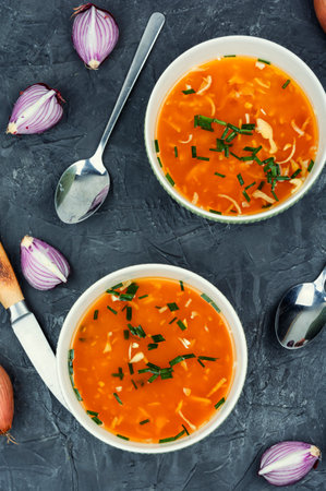 Tasty homemade onion soup in a ceramic bowl. Vegetarian food. Top view.の写真素材