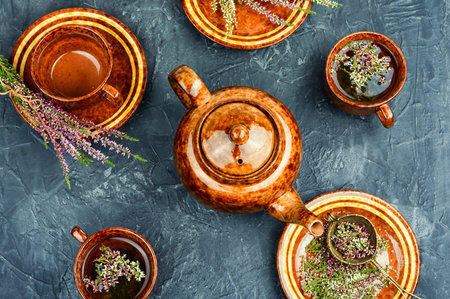 Teapot and medicinal herbs on table. Heather herbal tea in a mug on a table. Flat lay.の写真素材
