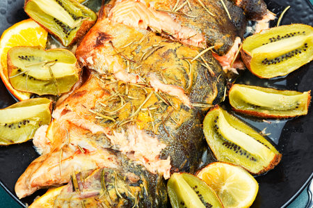 Whole trout fish baked in an oven with kiwi. Close up.の写真素材