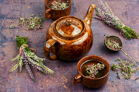 Fresh heather or Calluna vulgaris flowers with a cup of heather herbal tea.の写真素材