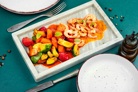 Plate of delicious Asian style cuisine with shrimp in a tropical fruits sauce.