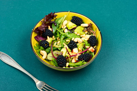 Vegetarian salad with greens, avocado, pine nuts and blackberries.の写真素材
