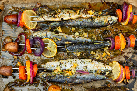 Fish kebabs, sardines on skewer, barbecue grill. Grilled sardines with vegetables. food backgroundの写真素材