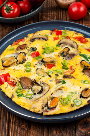 Homemade frittata or omelette, made with egg, mussels, bell pepper and mushroom.の写真素材