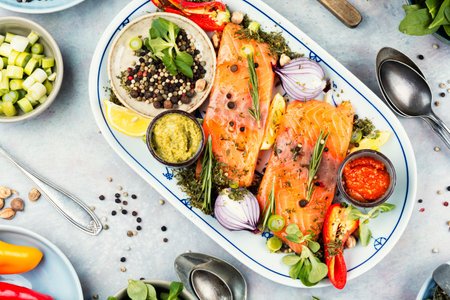 Marinated salmon. Fresh raw salmon fillet steak in dark background, healthy eating concept.の写真素材