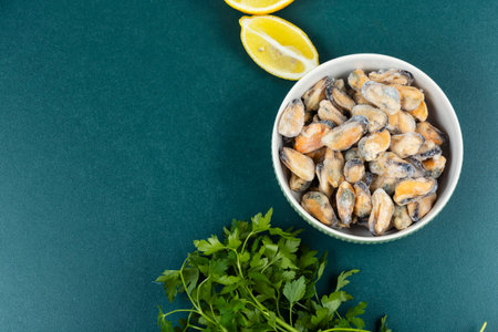 Heap of frozen peeled mussel meat, iced mussels.