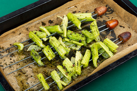 Roasted vegan skewers, celery kebabs. Plate of celery skewers, veggie style.の写真素材