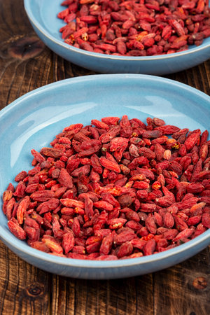 Natural goji berry snack. Goji berries in plate. Vegetarian and vegan food.