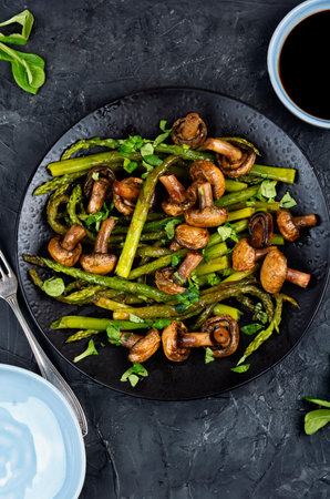 Organic green asparagus fried with mushrooms and greens.の写真素材