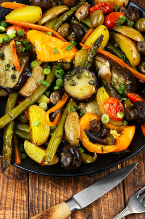 Grilled vegetables platter, roasted eggplants, potatoes, mushrooms and green asparagus on wooden surface.の写真素材