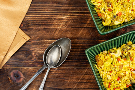 Aromatic middle eastern spices with raisins, nuts, colorful spices on rustic wooden table. Colorful spices for cooking.の写真素材