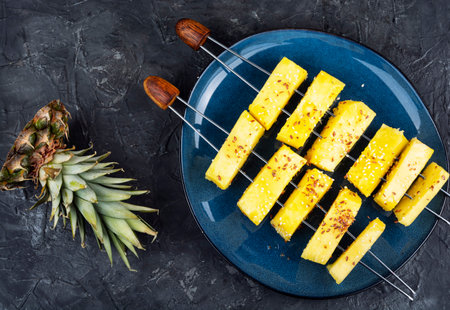 Colorful fresh fruit such as pineapple chunks on wooden skewers. Flat lay,の写真素材