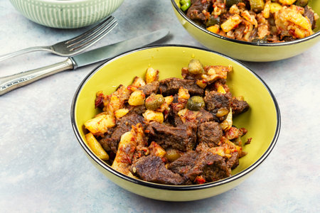 Traditional Tatar dish azu. Fragrant beef meat with tomatoes and pickles in a thick sauce in a plate.の写真素材