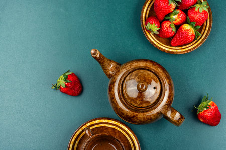 Tea in a glass teapot from the strawberries. Space for text.の写真素材