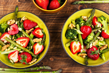 Healthy food, a vibrant spring salad with strawberries, broccoli and green asparagus.の写真素材