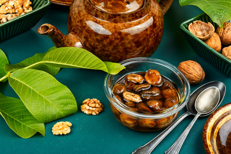 Jam made from green fresh walnuts and peeled walnut. Green fresh walnut dessert.の写真素材