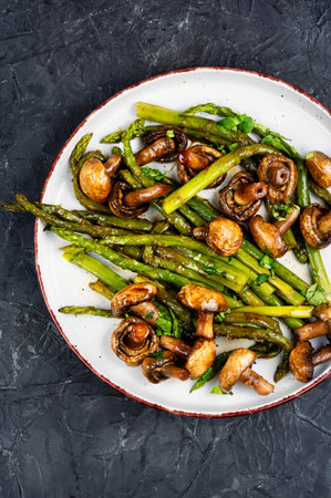 Grilled green asparagus spears and sauteed champignon mushrooms. Low-calorie. Roasting vegetables. Flat layの写真素材