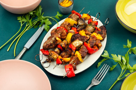 Grilled meat and vegetables on skewers, shish kebab with mushrooms. Food photographyの写真素材