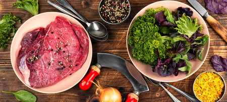 One piece of raw beef with ingredients for cooking. Top view.の写真素材