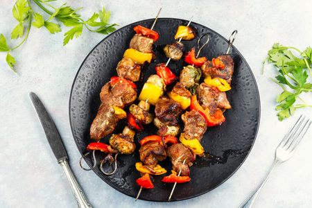 Flavorful kebabs - grilled meat and vegetables on skewers, BBQ skewers. Top view.の写真素材