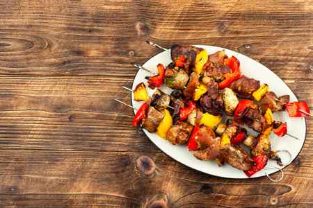 Meat skewers with grilled vegetables on a plate, kabobs on the BBQ. Copy space, space for text.の写真素材