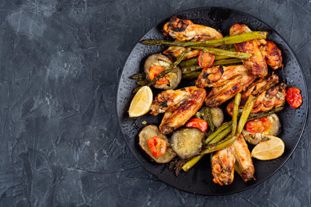 Fried chicken wings with asparagus, Hot and spicey chicken wings. BBQ. Flat lay with copy spaceの写真素材