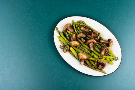 Roasted asparagus with champignon mushrooms. Flat lay with copy spaceの写真素材