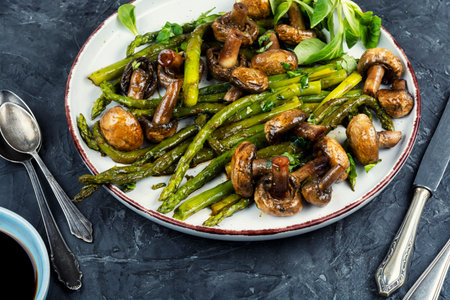 Delicious and healthy food. Roasted or fried baked asparagus with mushrooms.の写真素材