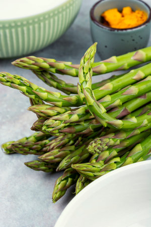 A bunch of green asparagus, fresh, raw green asparagus. An edible, raw stems of asparagus.の写真素材