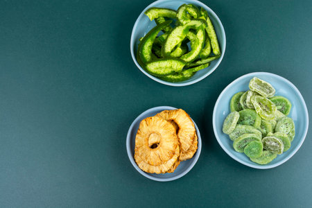 Candied tropical fruits dried candied fruits. Kiwi, mango and pineapple rings. Organic food. Copy space.の写真素材