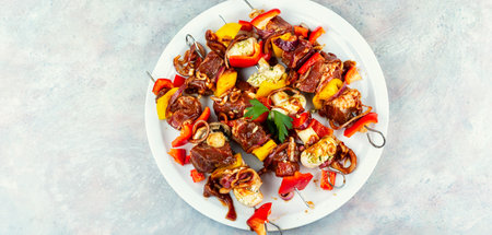 Freshly Prepared Meat Skewers with Vegetables Ready for Grilling. Marinated, Succulent Meat.の写真素材