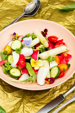 Salad with white asparagus, cucumbers, tomatoes and edible flowers. Food photography.の写真素材