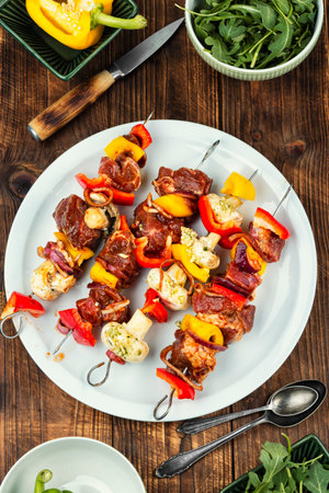 Raw meat skewers garnished with vegetables. Preparing meat for barbecue grill.の写真素材