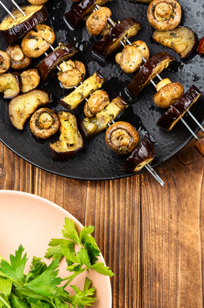 Grilled champignon mushrooms with grilled eggplant on skewers. Vegetarian grill skewers.の写真素材