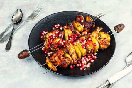Delicious food photography of smoky chicken wings on skewers.の写真素材