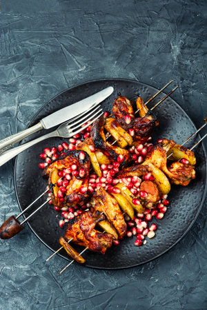 Grilled chicken kebab on plate with metal skewers sticks.の写真素材