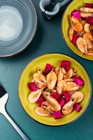Spicy shrimp, fried seafood. Roast prawns shrimps with pitaya, dragon fruit and garlic.の写真素材