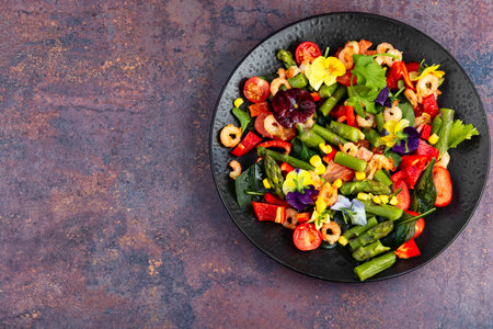 Fresh seafood salad with roasted shrimp, edible flowers and vegetables. Copy space.の写真素材