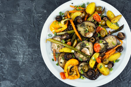 Roasted vegetables in the oven, baked or grilled vegetables. Baked sliced vegetables. Space for text.の写真素材