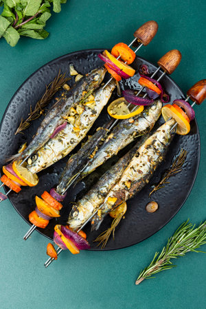 Skewers, of sardines roasting on an open fire. Typical dish on the Spanish Mediterranean. Fish kebab.の写真素材