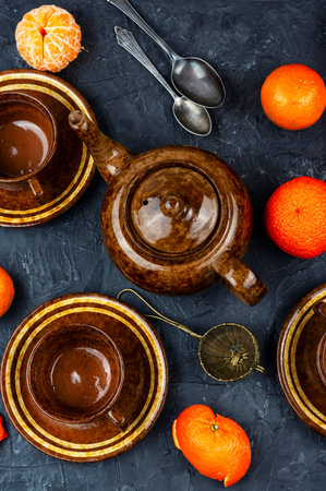 Cups of tea, teapot, mandarins or tangerines. Clementines teaの写真素材