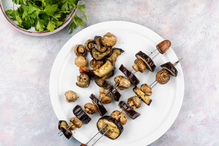 Grilled vegetable skewers featuring mushrooms and eggplant, summer picnics or barbecue.の写真素材